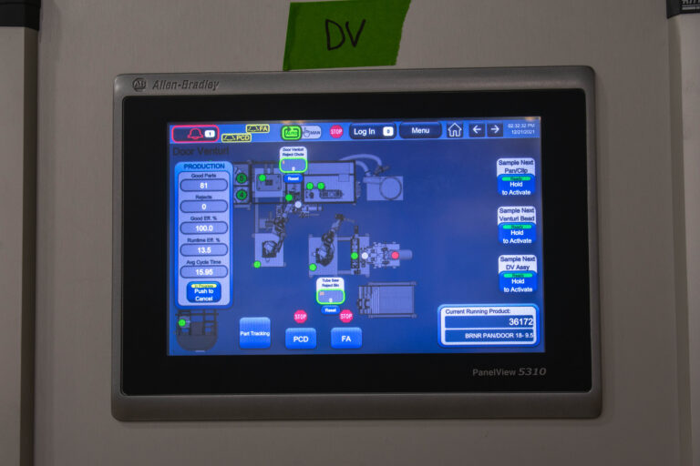 Allen-Bradley digital screen of the floor map of a factory with digital images of robotic arms and production rate times. This is the PanelView 5310 with various other buttons to press.