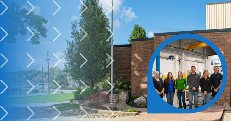 Landscaped photo of a brick building, flagpole, and various plants with an overlay of a circular photograph of staff members to show that the work for the company.