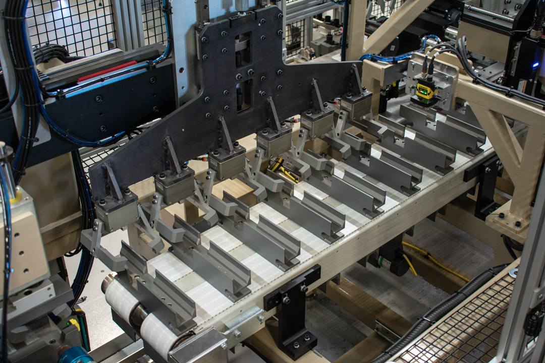 Low friction crossed-roller slide with custom grippers