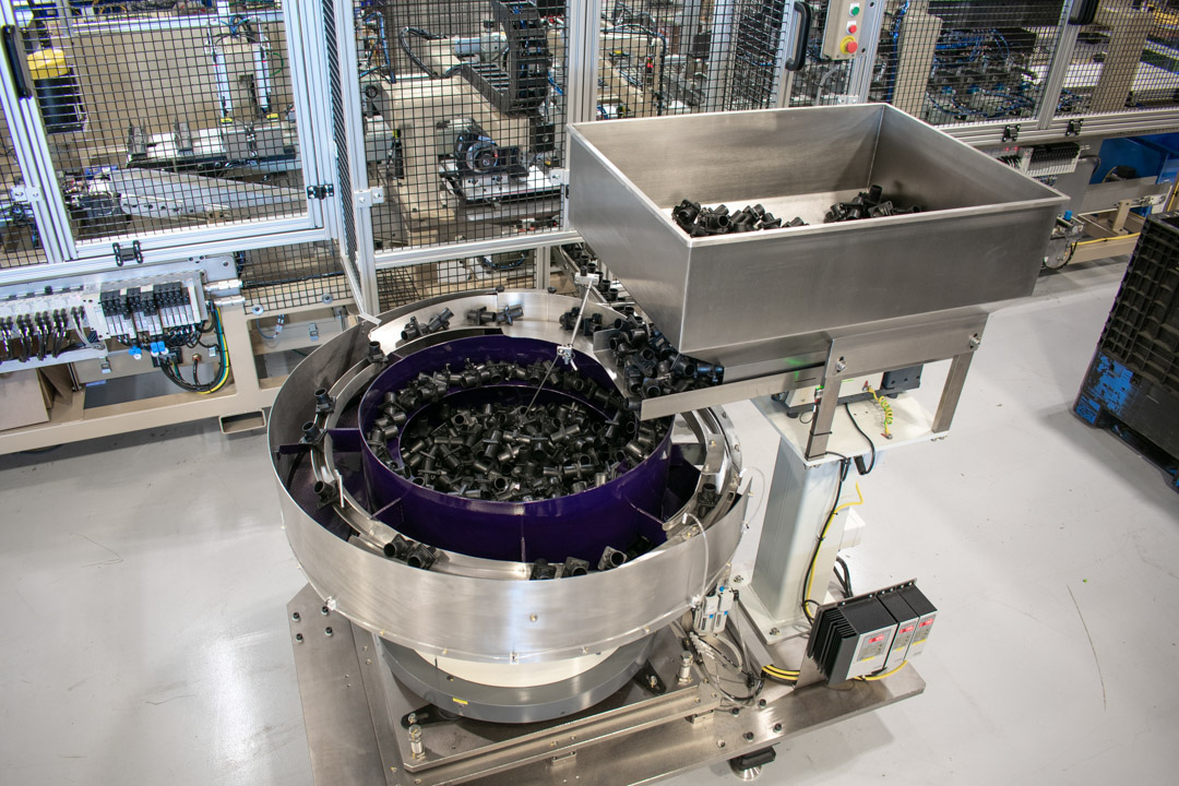 Bellco vibratory feeder bowl on an automated testing machine