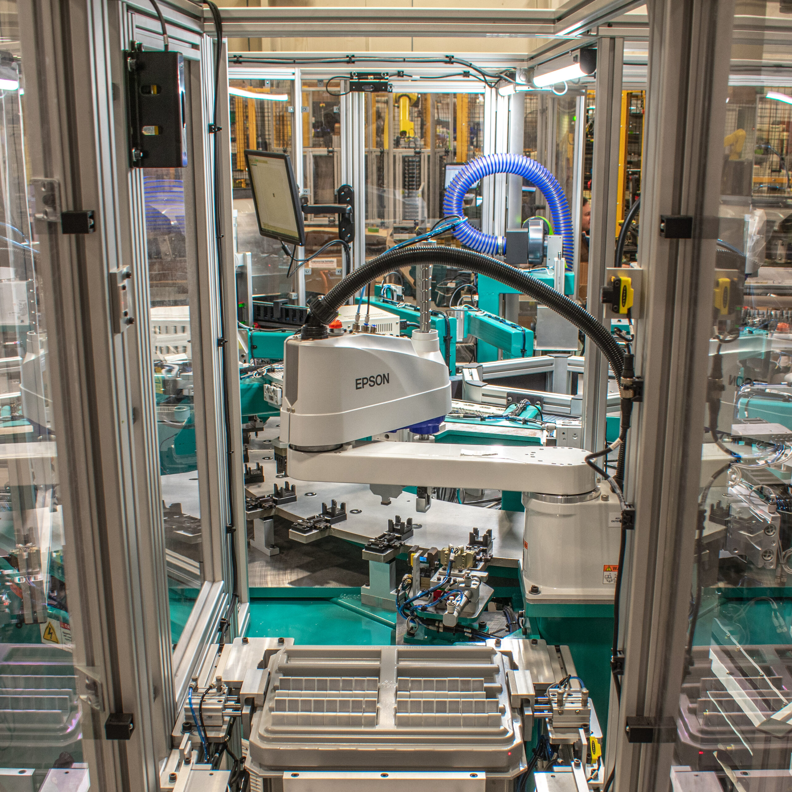 Teal and gray automated assembly machine.
