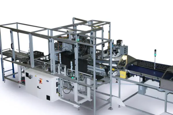 Image depicts a complex automated assembly line, composed of conveyor belts, robotic arms, and various processing stations. The machinery consists of a gray metal framework.