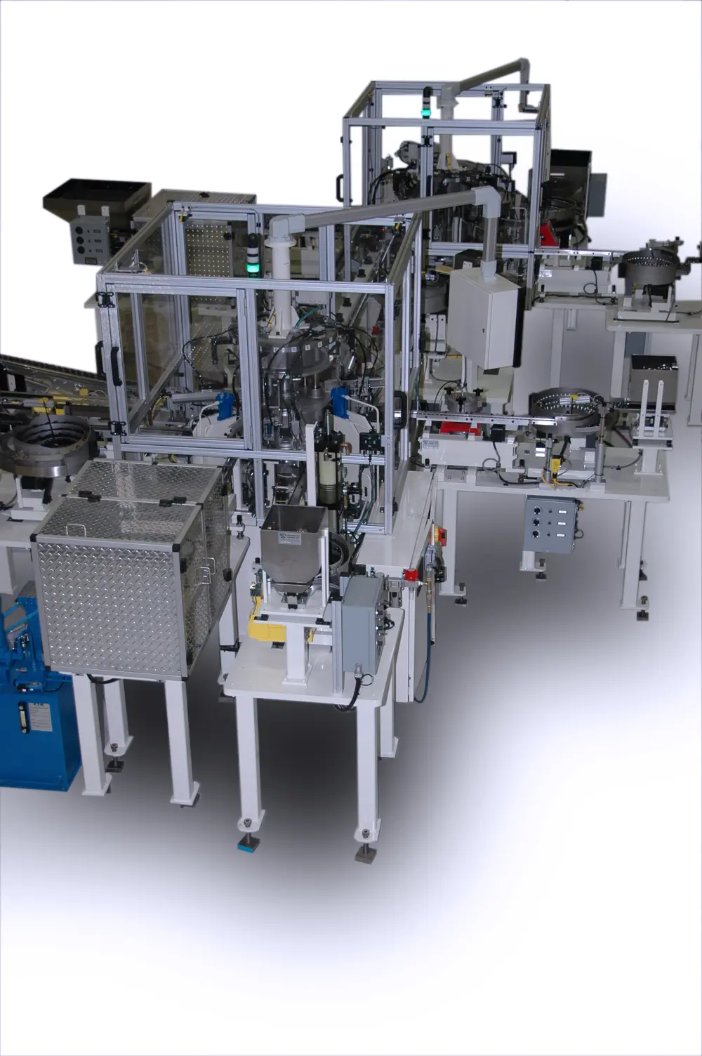 An industrial automated machine composed of metal structures, conveyors, and various processing stations with protective enclosures against a clean white background.