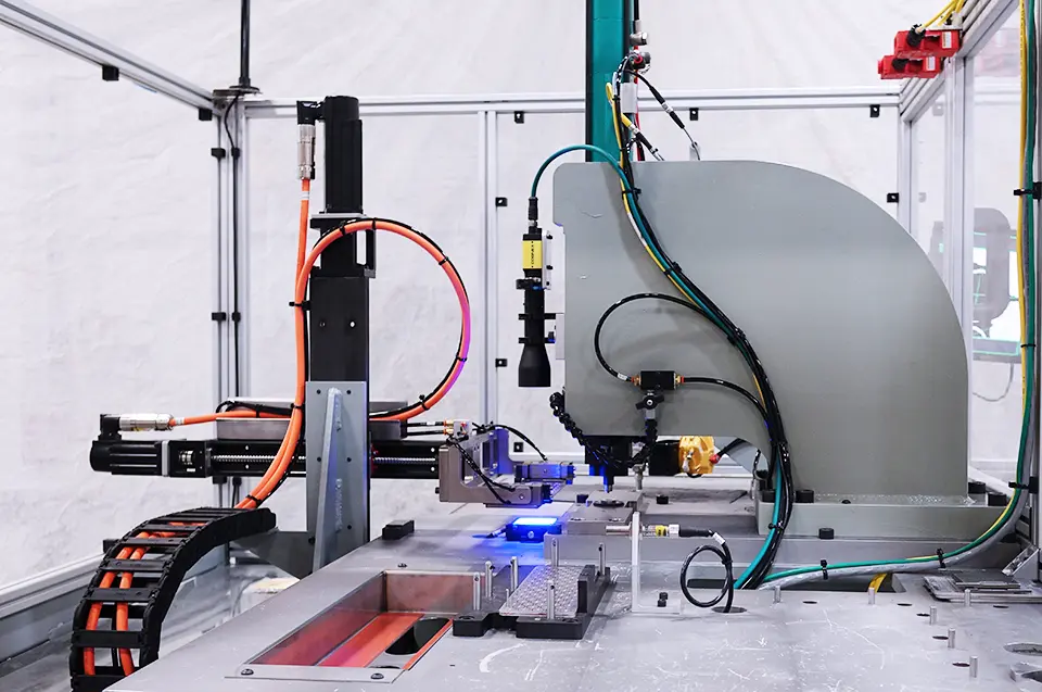 Cognex camera system over a blue light within clear machine guarding and attached to multiple other components.