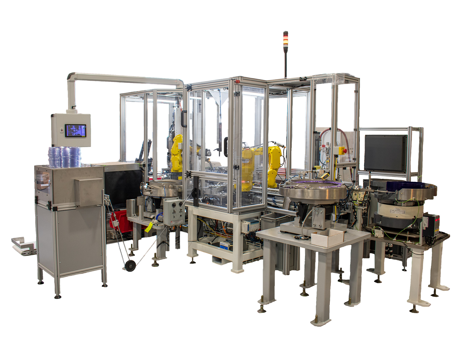 A complex automated assembly line features multiple robotic arms and feeder systems enclosed in protective transparent frames.
