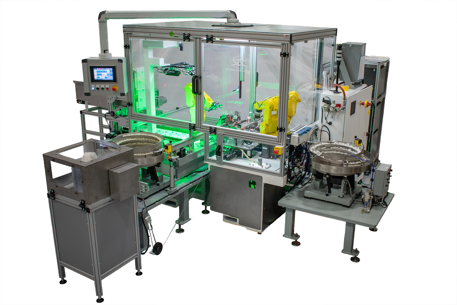 Manufacturing cell designed for small parts assembly. It features robotic arms visible inside a safety enclosure, feeders for parts, and a control panel with a screen display.