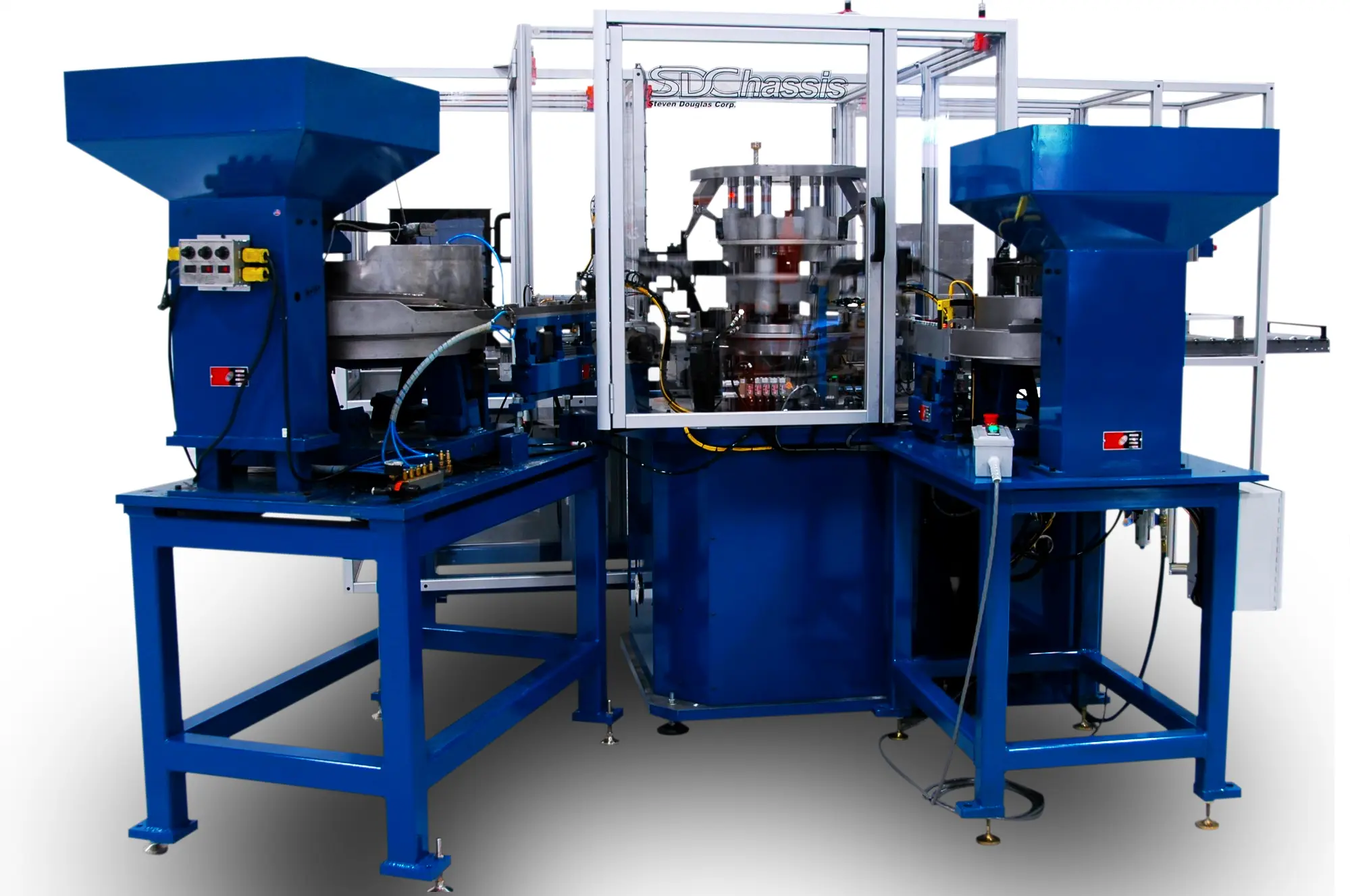 SDChassis machine surrounded by two industrial feeder bowls for bolt washer palletizing. Blue and silver structure with wires and components.