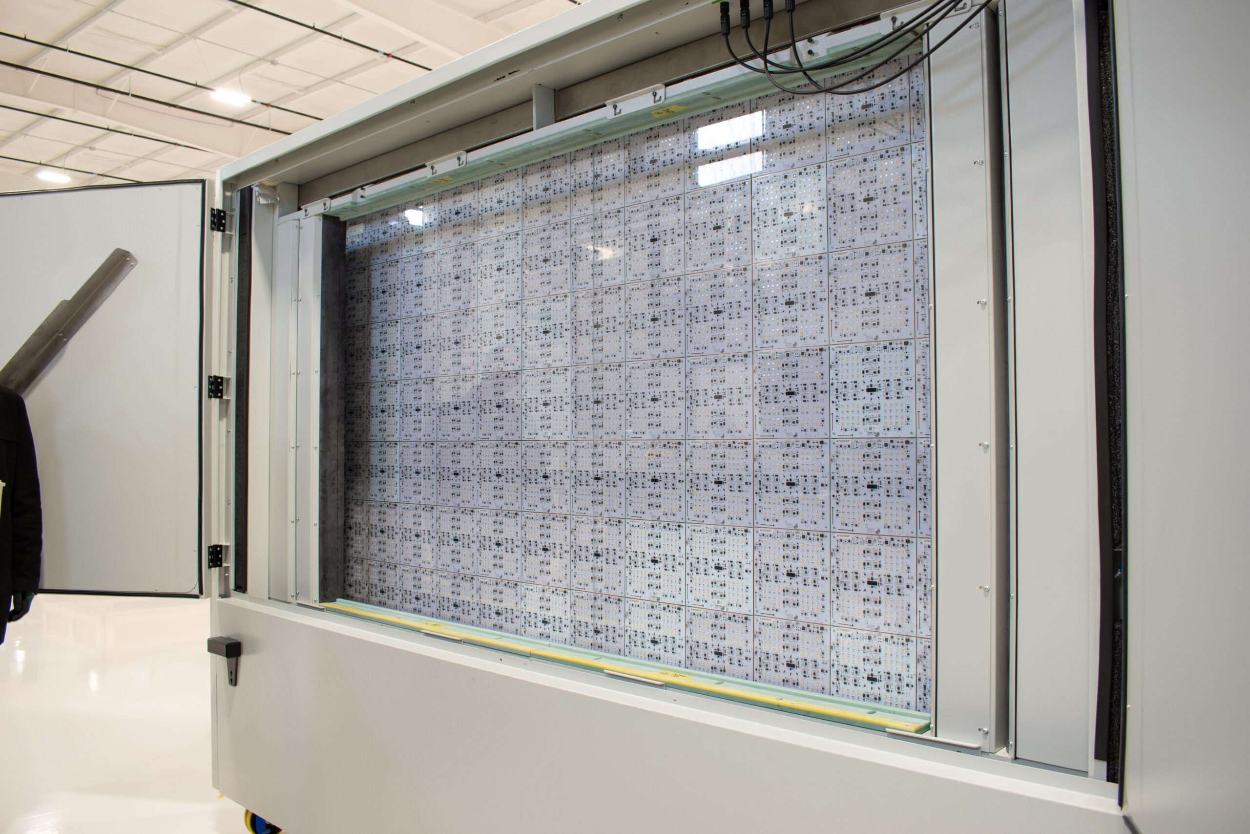 Array of printed circuit boards (PCBs) arranged in a grid pattern, enclosed in a frame.