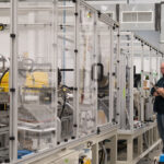 Engineers evaluating an automated packaging machine