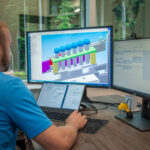 Mechanical engineer at his desk working on a SolidWorks drawing
