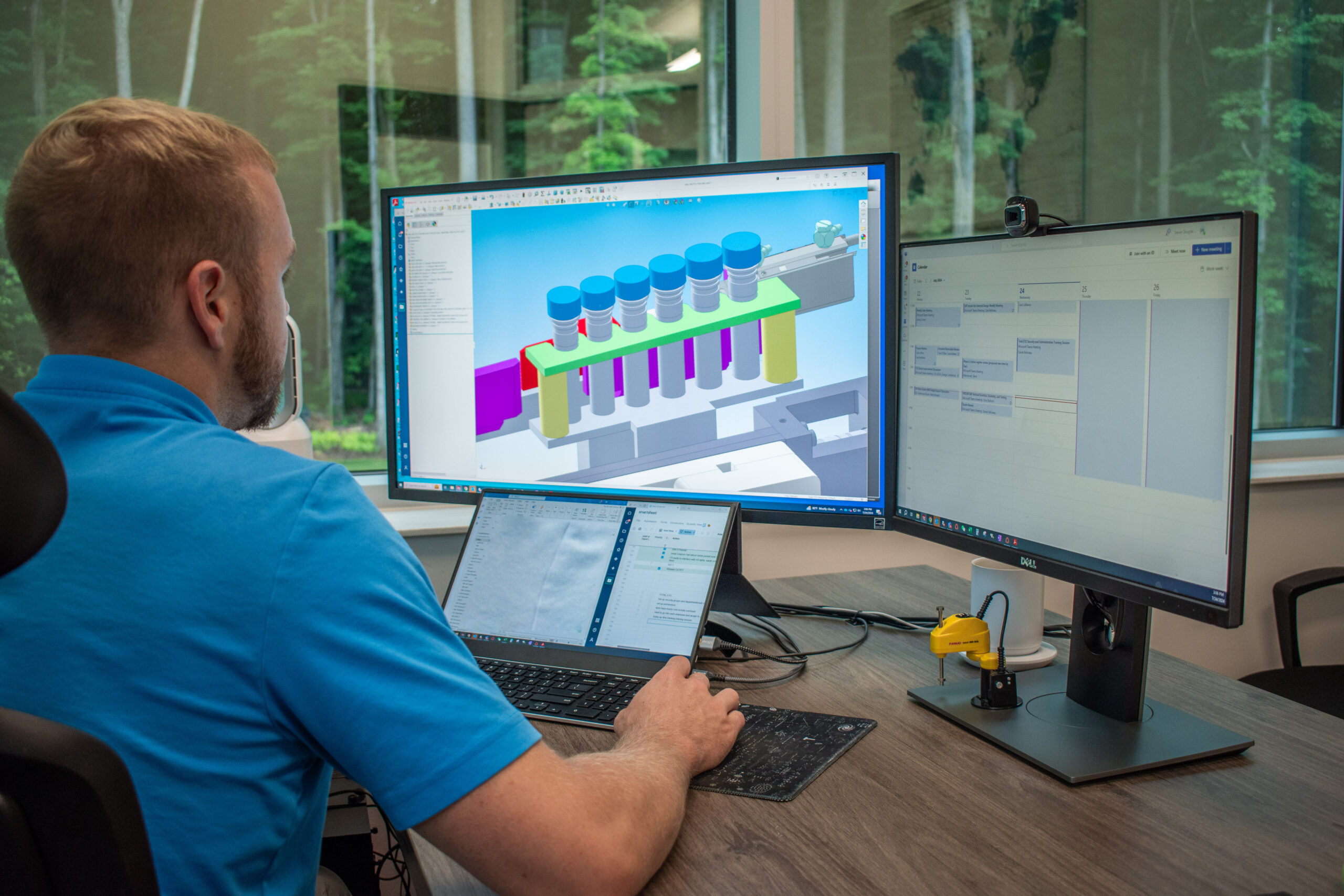 Mechanical engineer at his desk working on a SolidWorks drawing