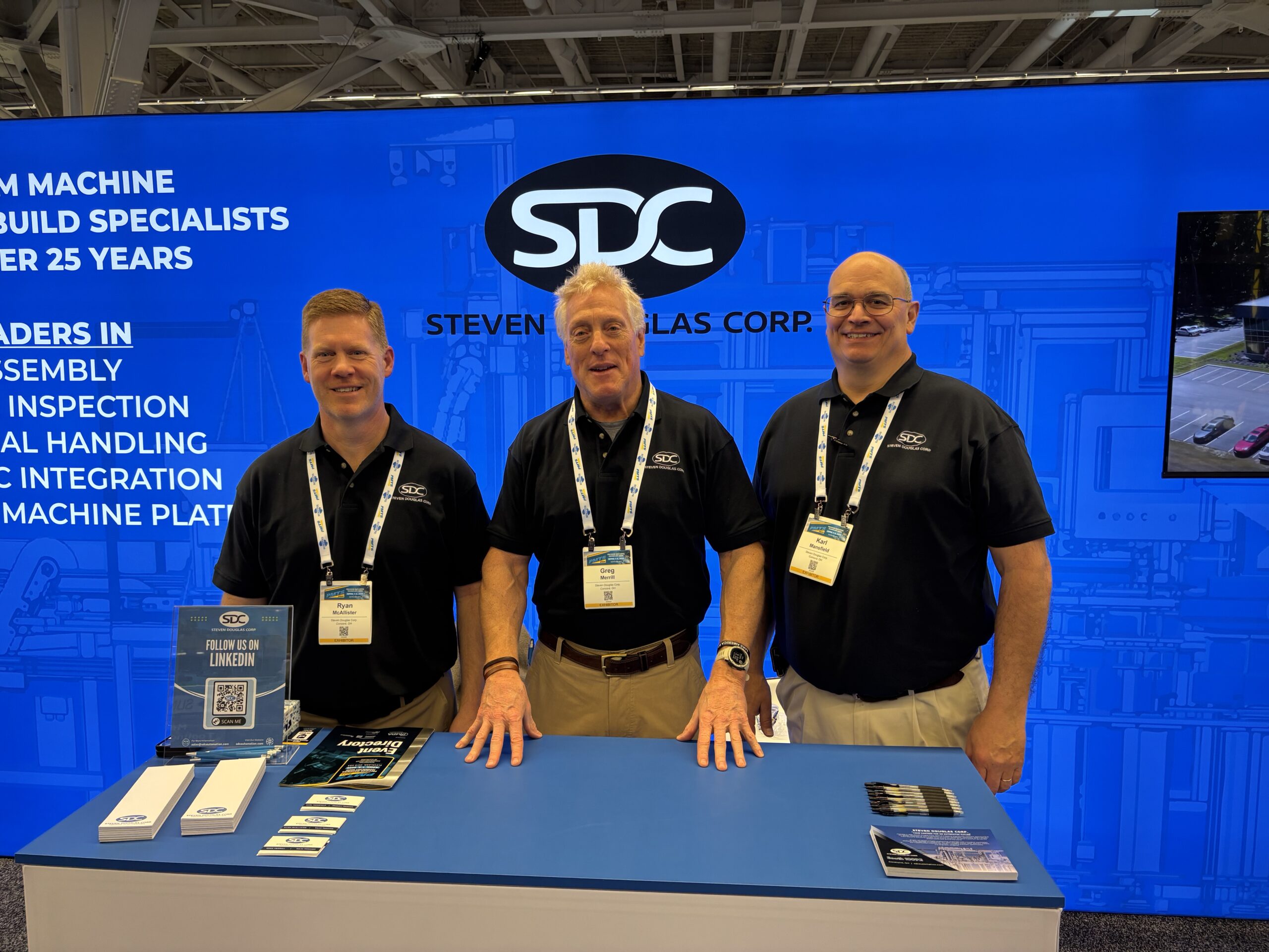 Three SDC team members posing for a picture in the SDC booth