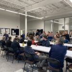 SDC employees in the breakroom for a meeting