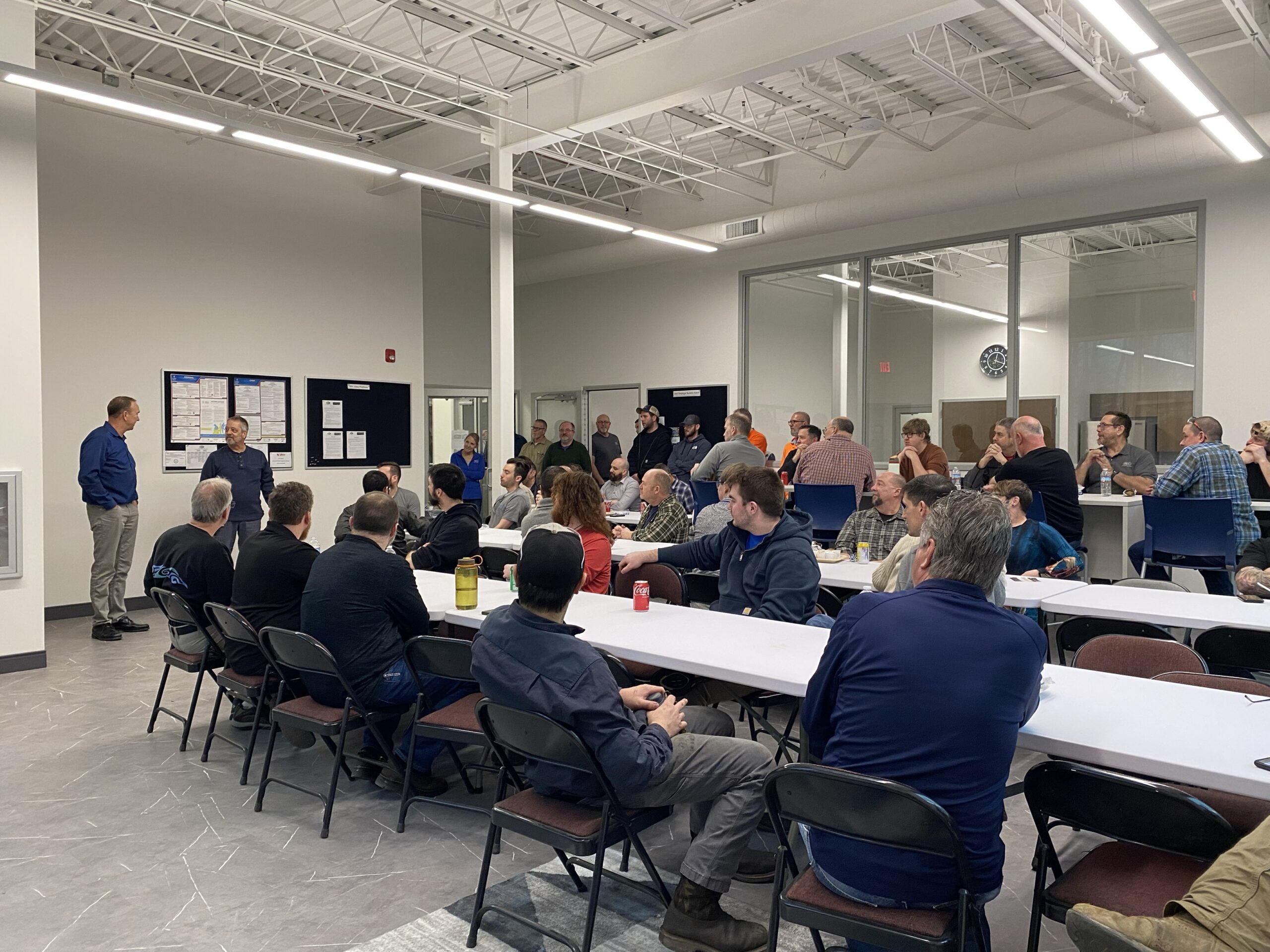 SDC employees in the breakroom for a meeting
