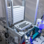 Epson robot arm assembling parts in a manufacturing setting. Automated process.