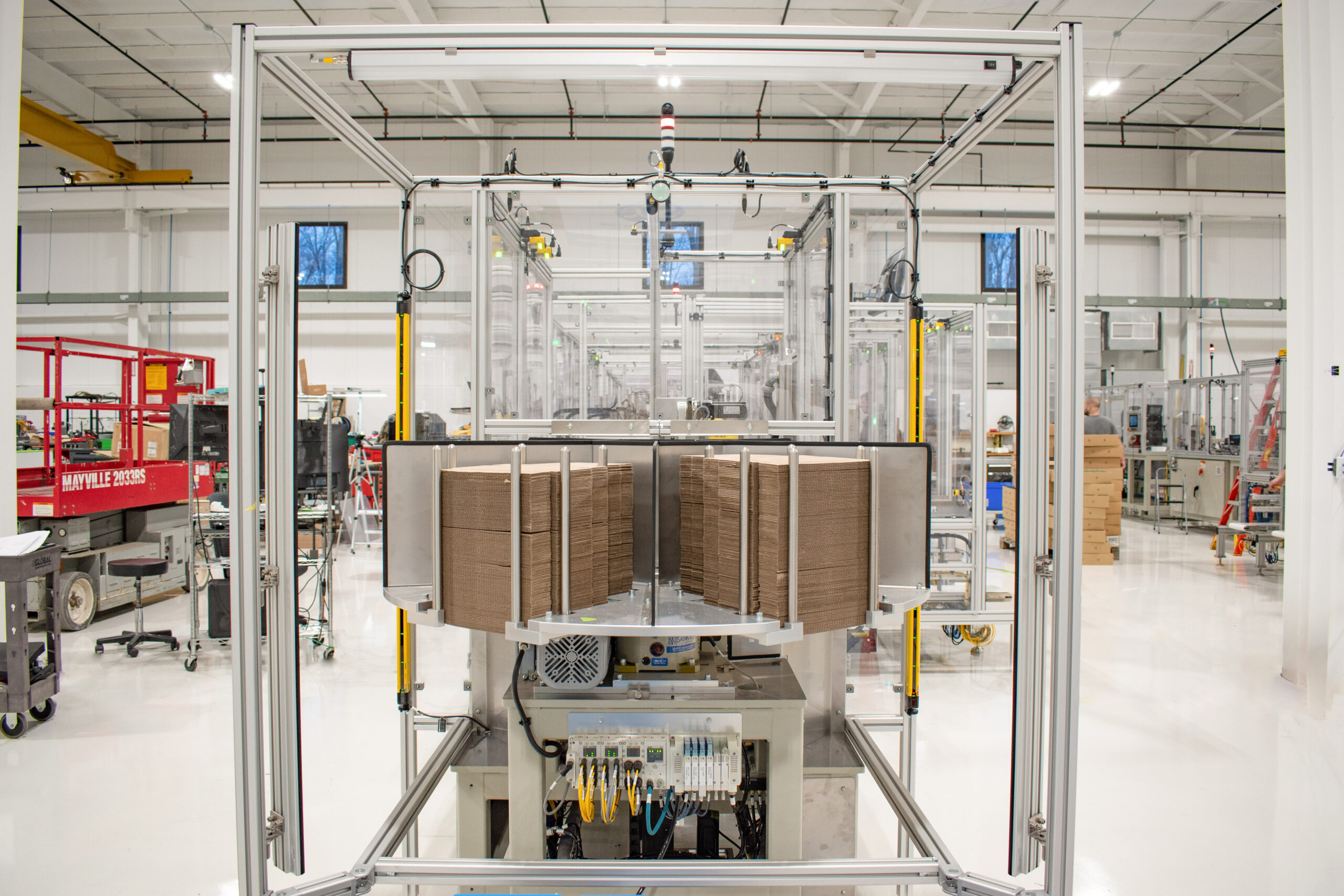 Rotary cardboard box supply for automated cartoning and packaging