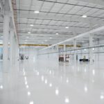 Clean inside of machine shop of SDC right after it was built. Empty floor with bright white lighting.
