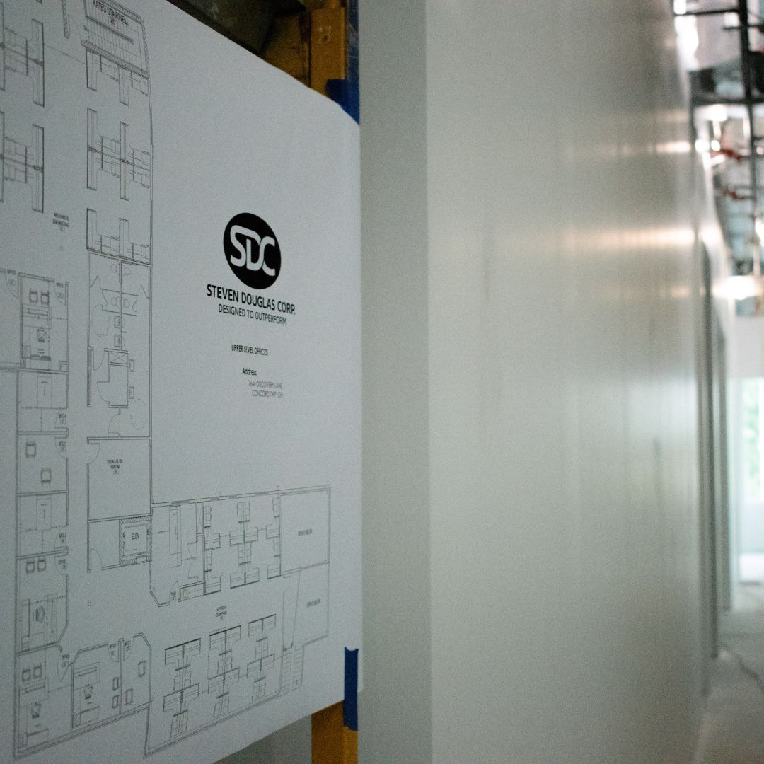 Floor plans hung on the wall that are drawn in black and white, hanging on the wall.