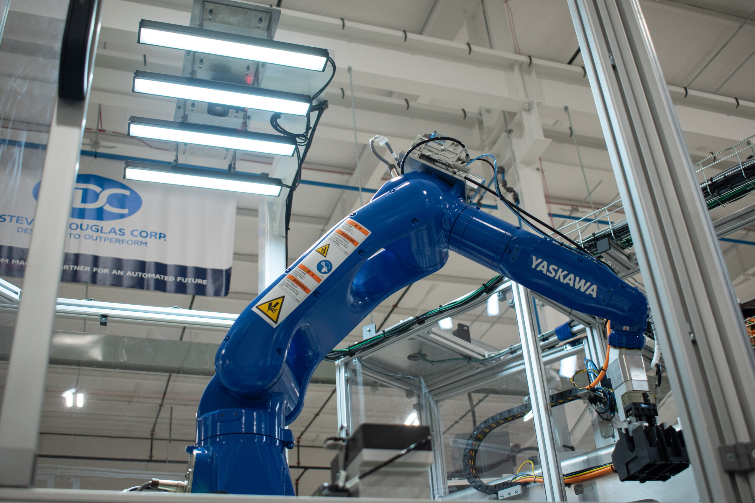 A Keyence overhead vision system working with a Yaskawa Motoman robot on an automated machine