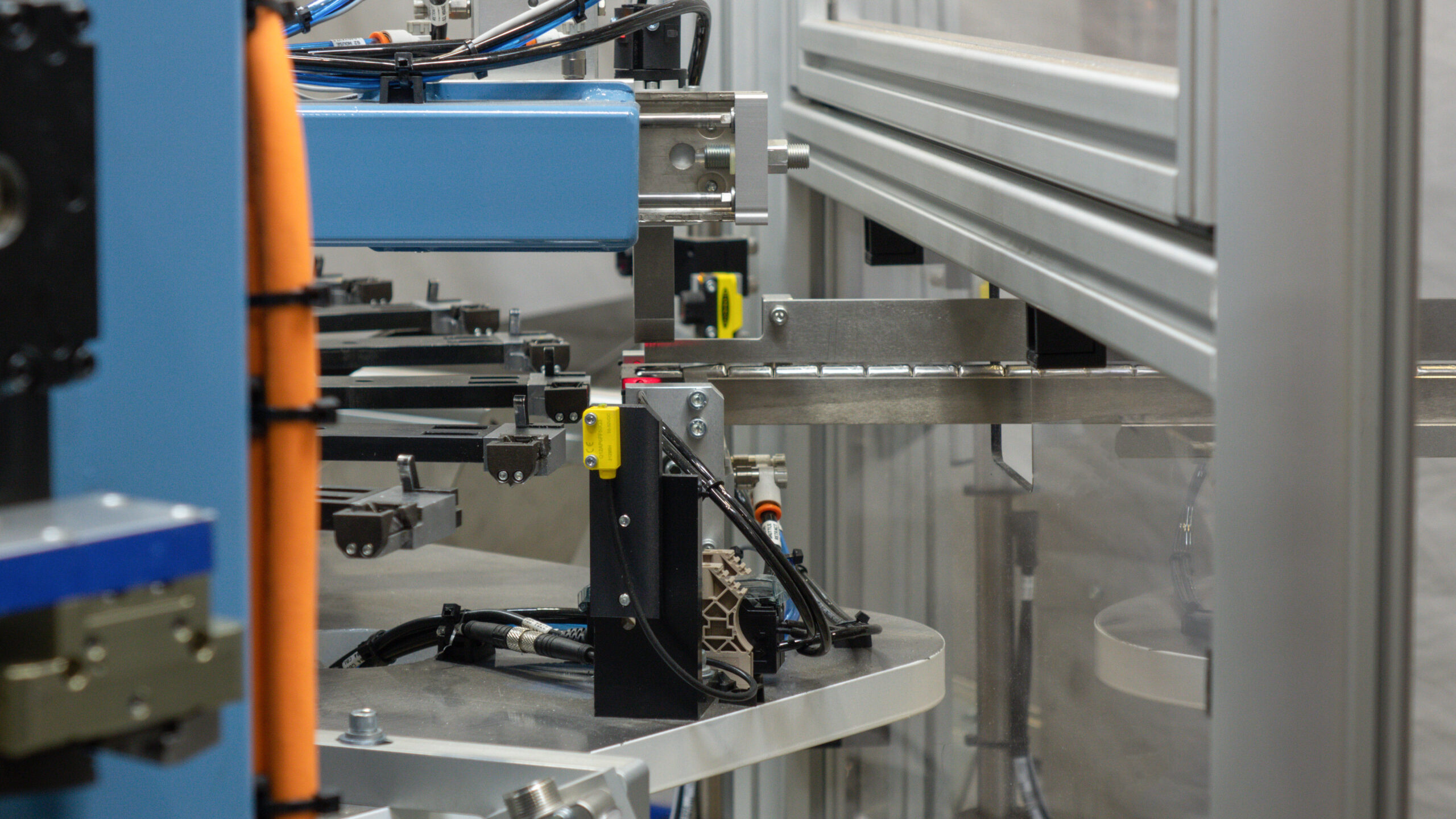 Linear inline track feeding parts into an automated machine