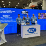 Four SDC team members standing in the SDC booth at Automate 2025