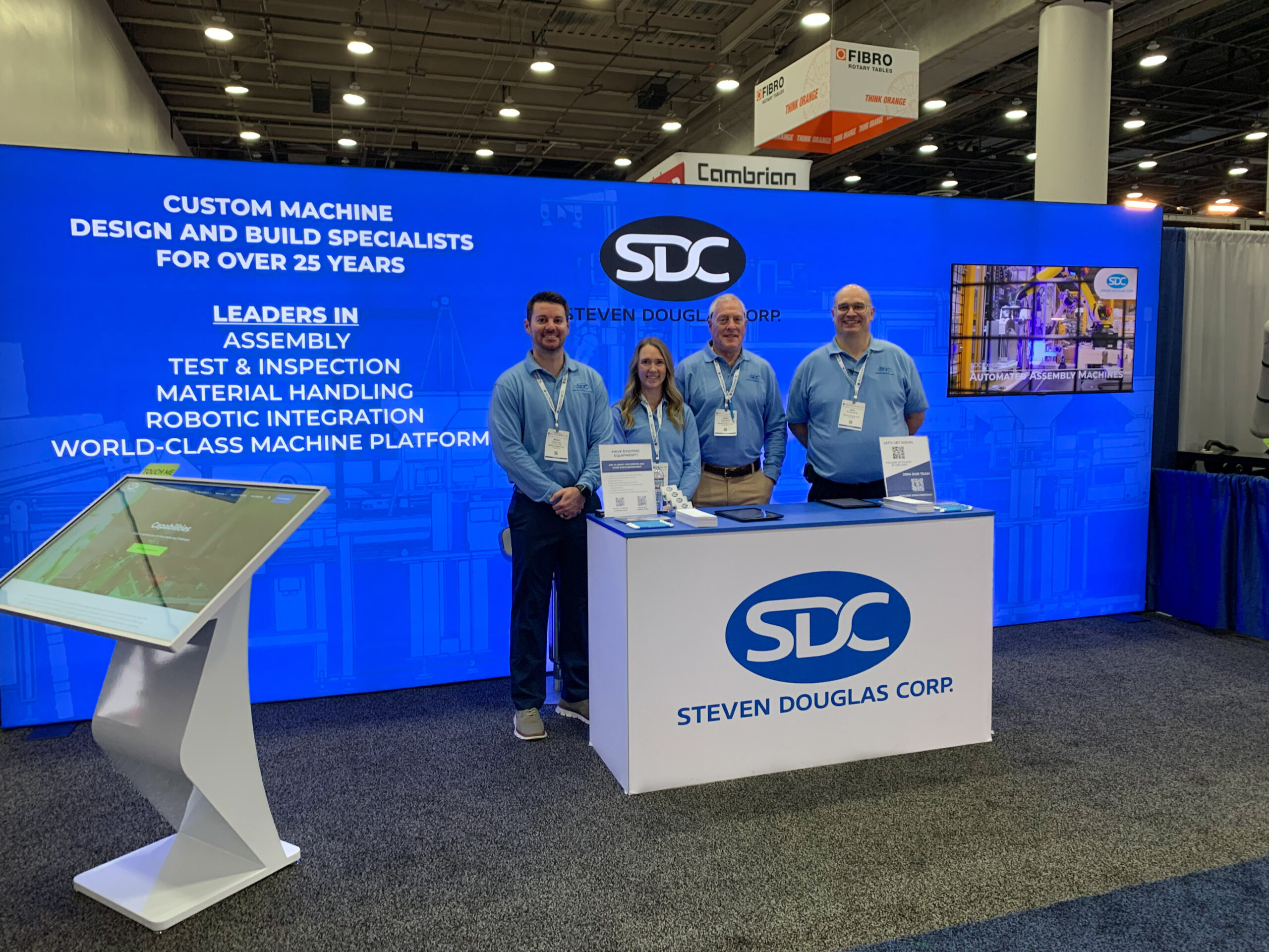 Four SDC team members standing in the SDC booth at Automate 2025