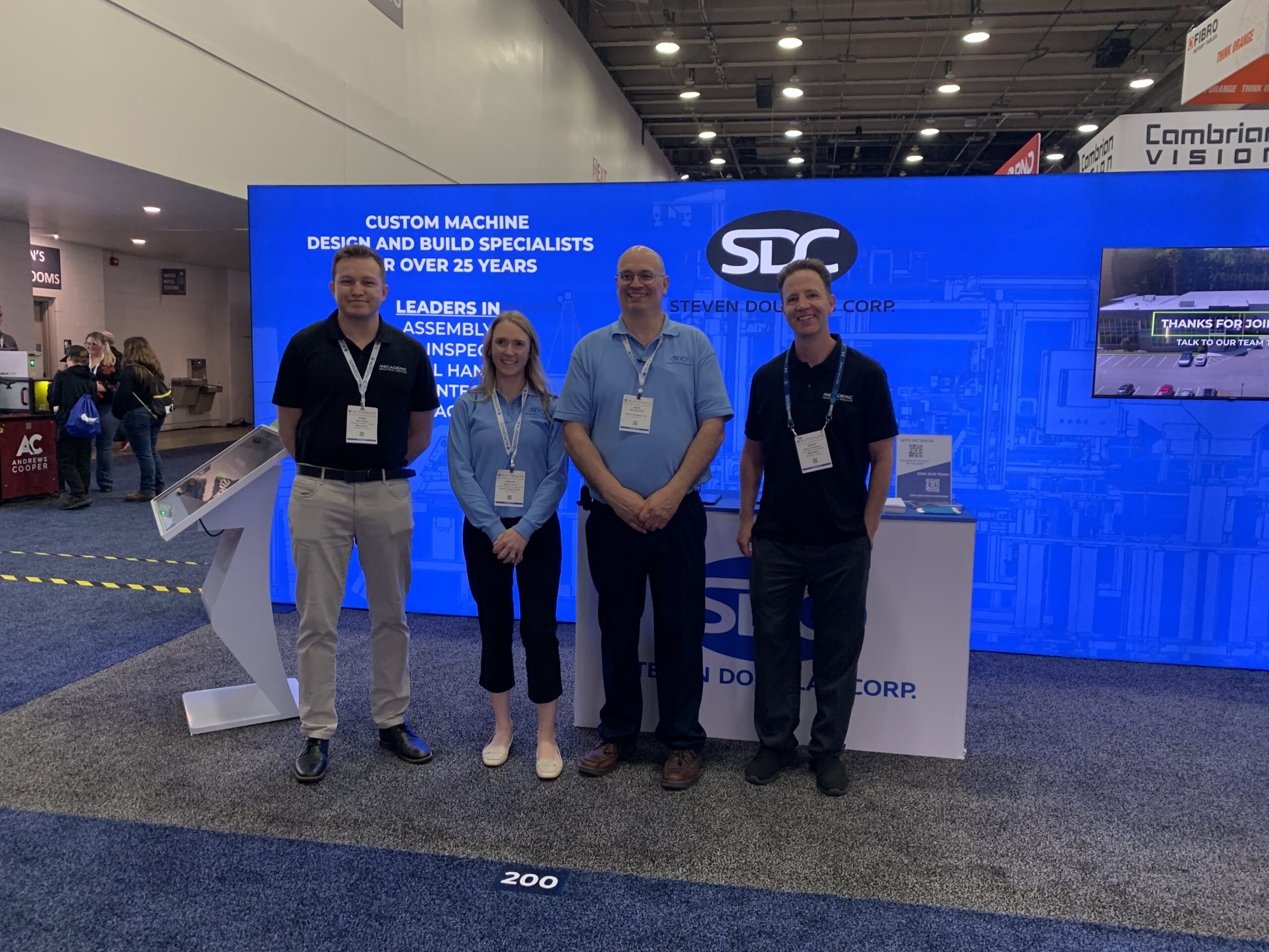 Some of the SDC booth team with robotics supplier, Mecademic