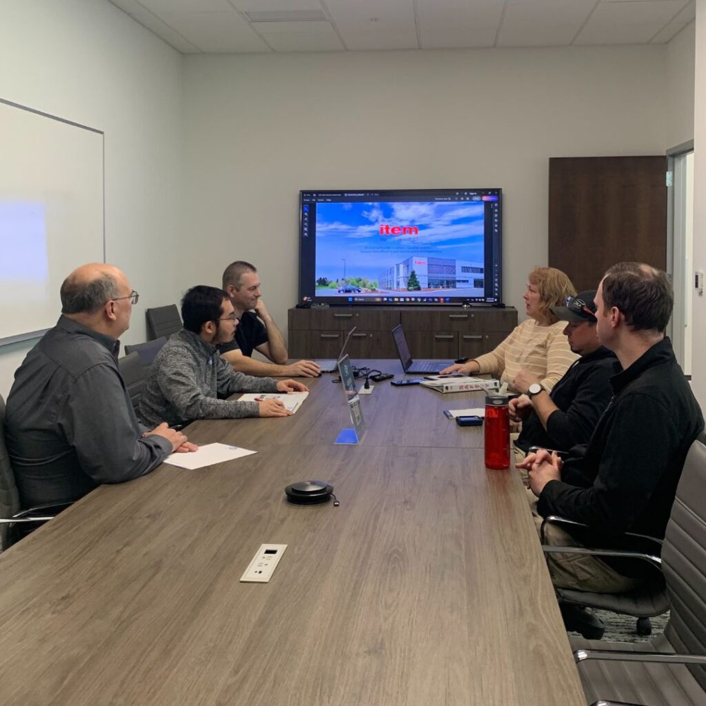 Safety committee meeting with a supplier at a conference table.