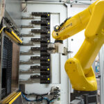 FANUC robot performing precision material handling on a solar simulation testing machine