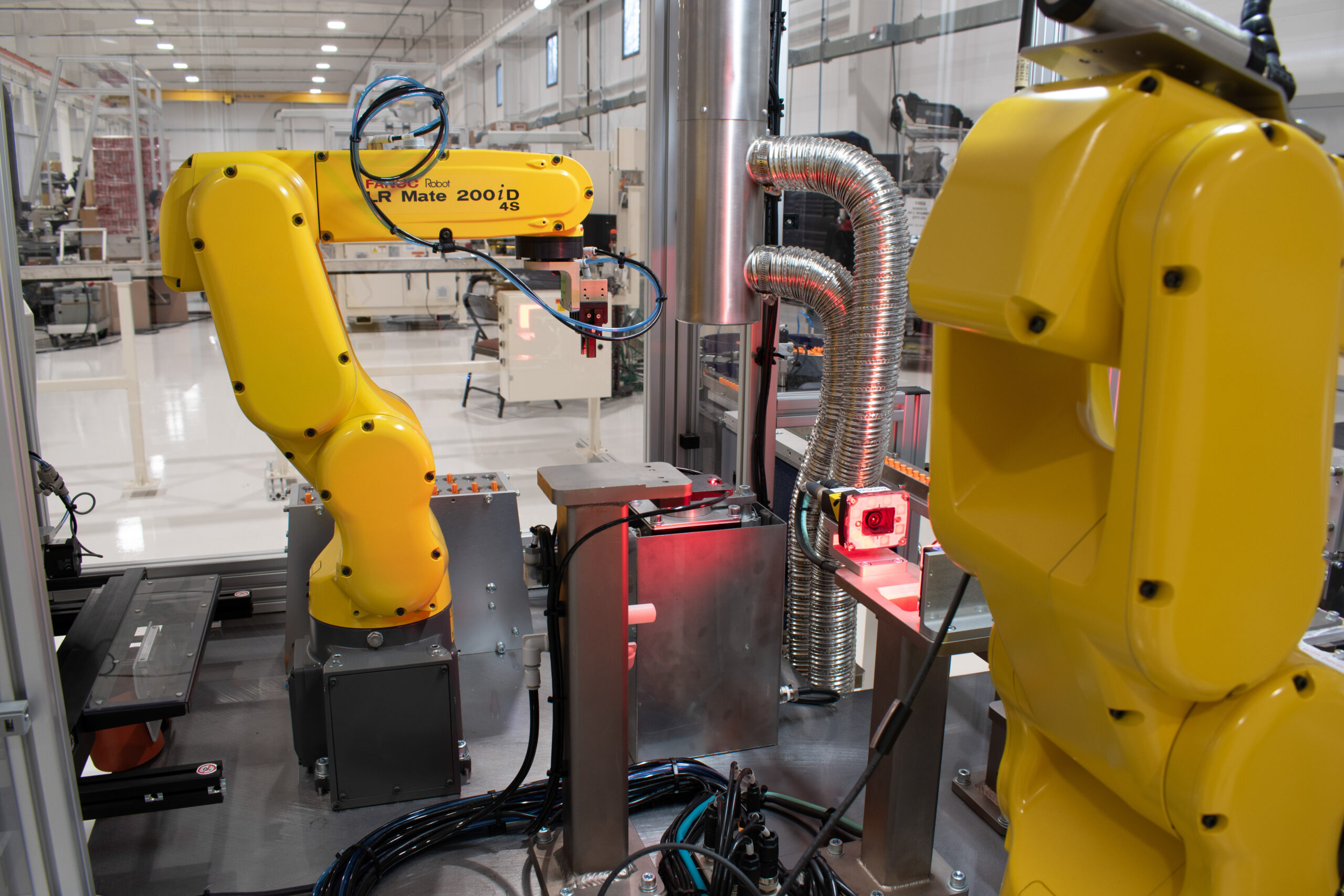 FANUC robots mounted on a medical device assembly automated machine