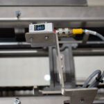 Verification sensor on a conveyor line