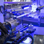 Purple lights on an inspection station for a consumer product assembly machine
