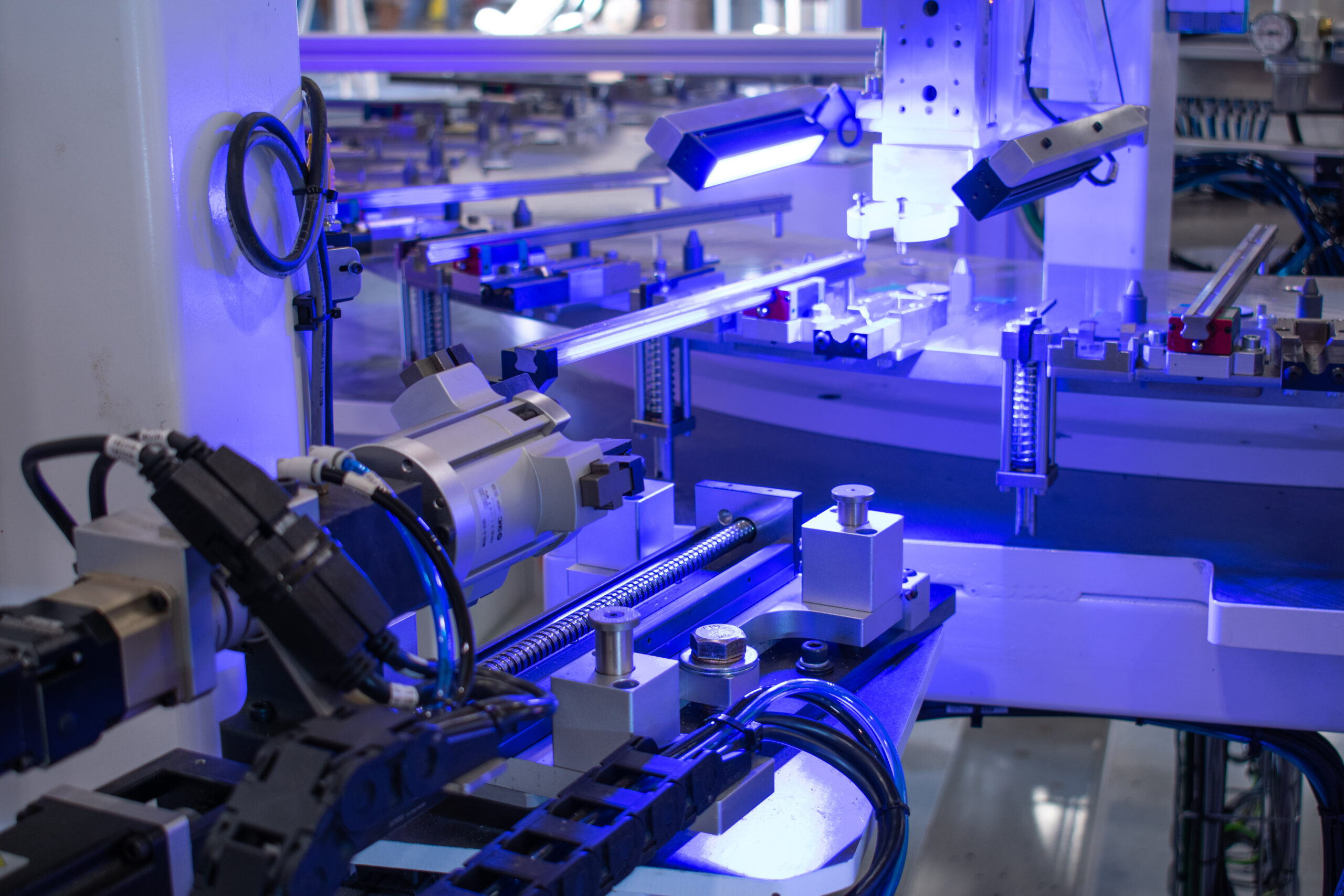 Purple lights on an inspection station for a consumer product assembly machine
