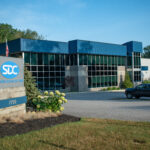 Side view of the SDC building and road sign in the summer