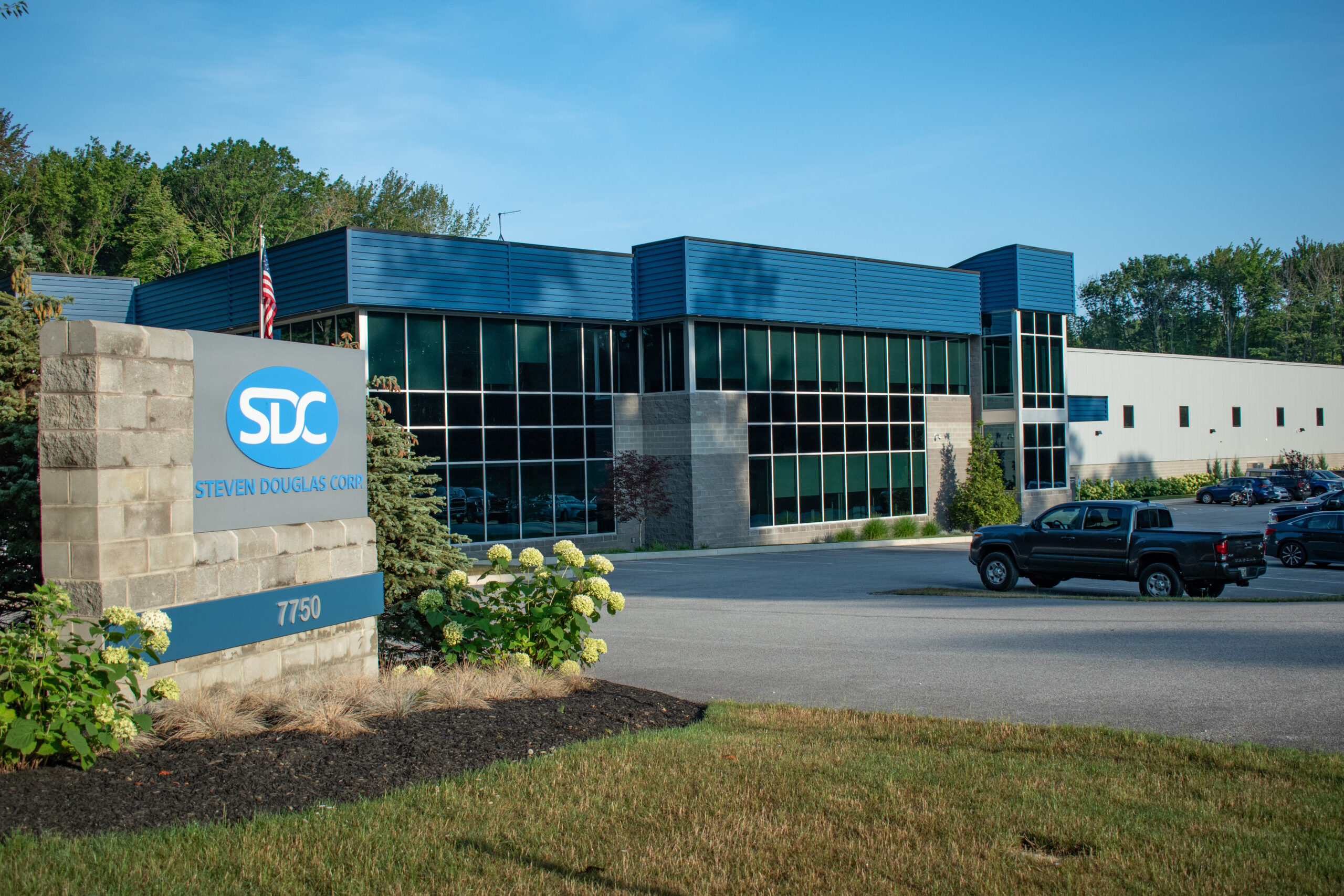 Side view of the SDC building and road sign in the summer