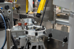 Medical tubing on a servo-driven automated coiling turret