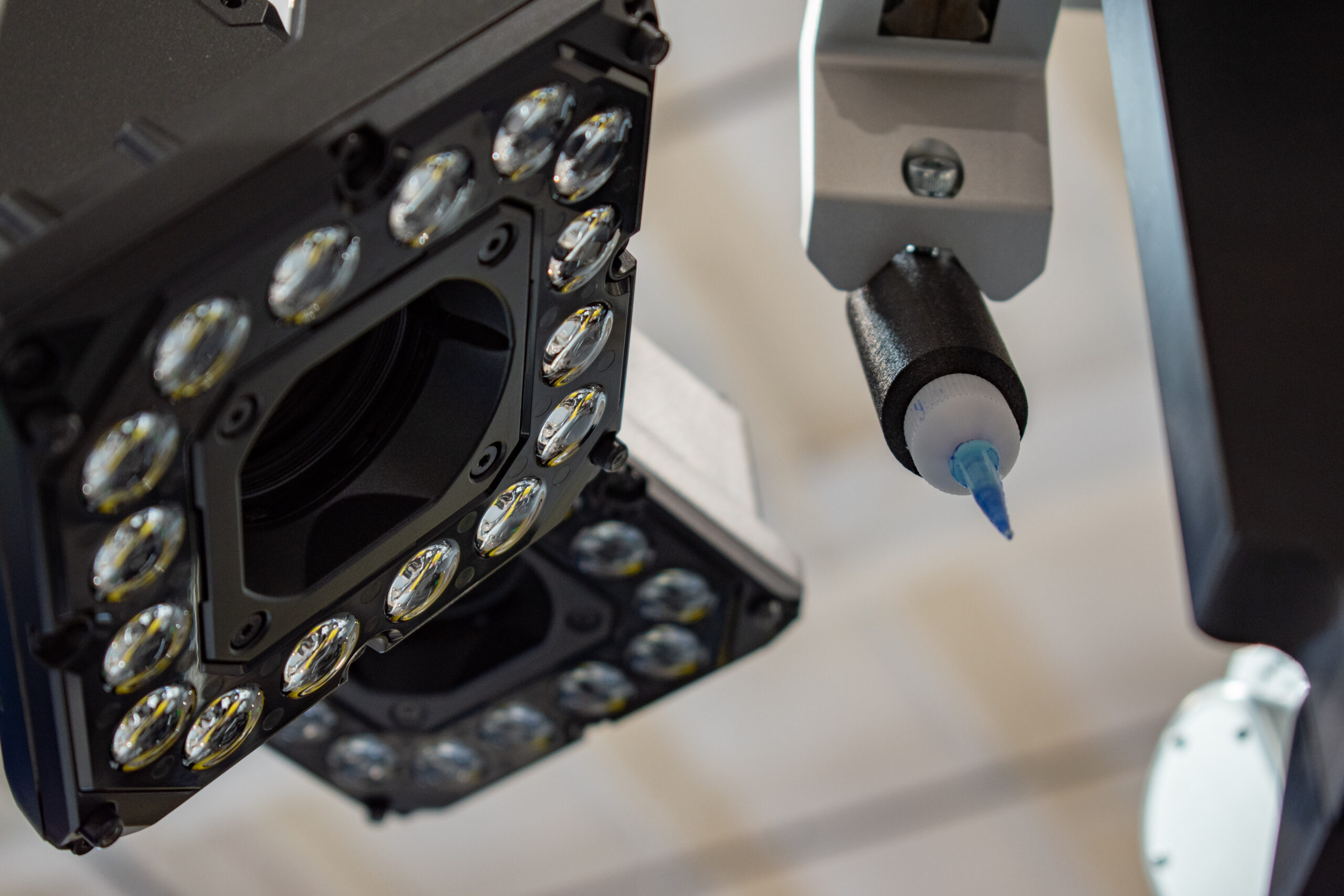 Cameras with lights and an adhesive dispenser