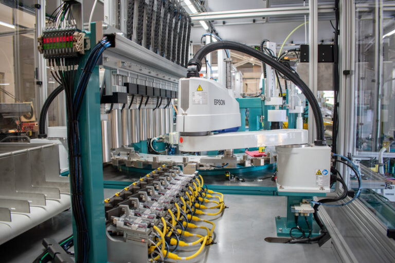 Epson SCARA robot mounted on an automated electrical testing station for terminals