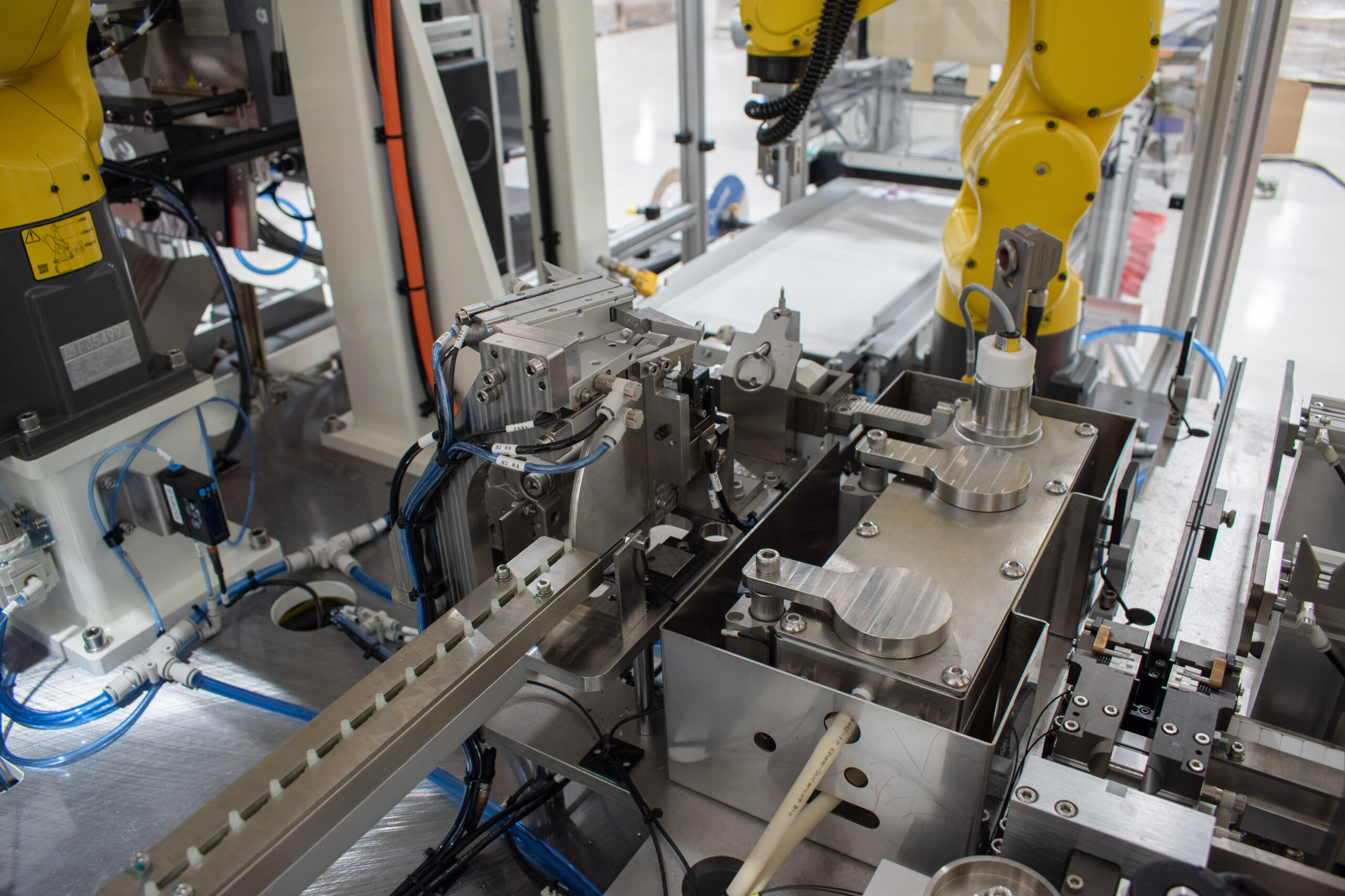 Linear track and primer dispensing area on an automated machine