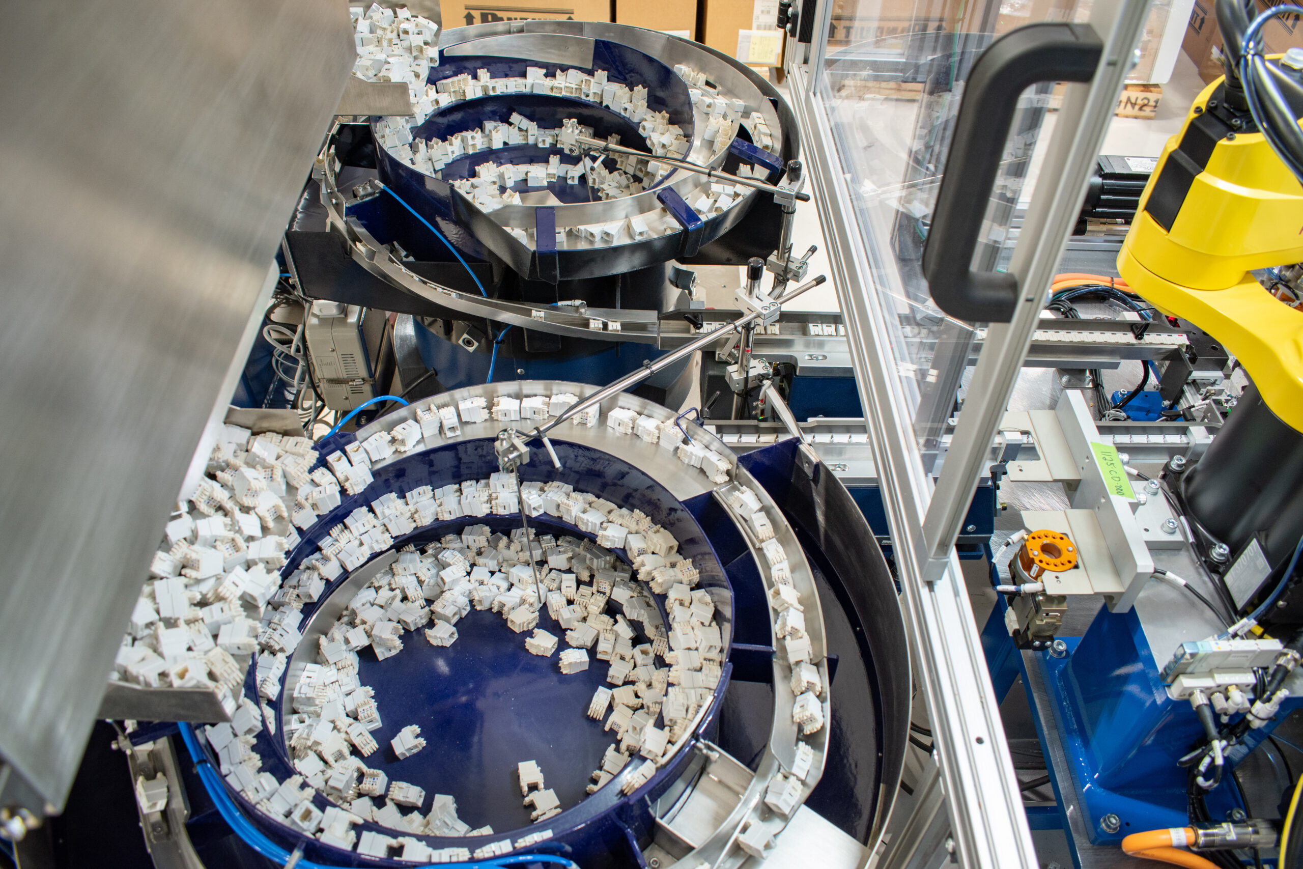 two Bellco feeder bowls on a foil applicator machine
