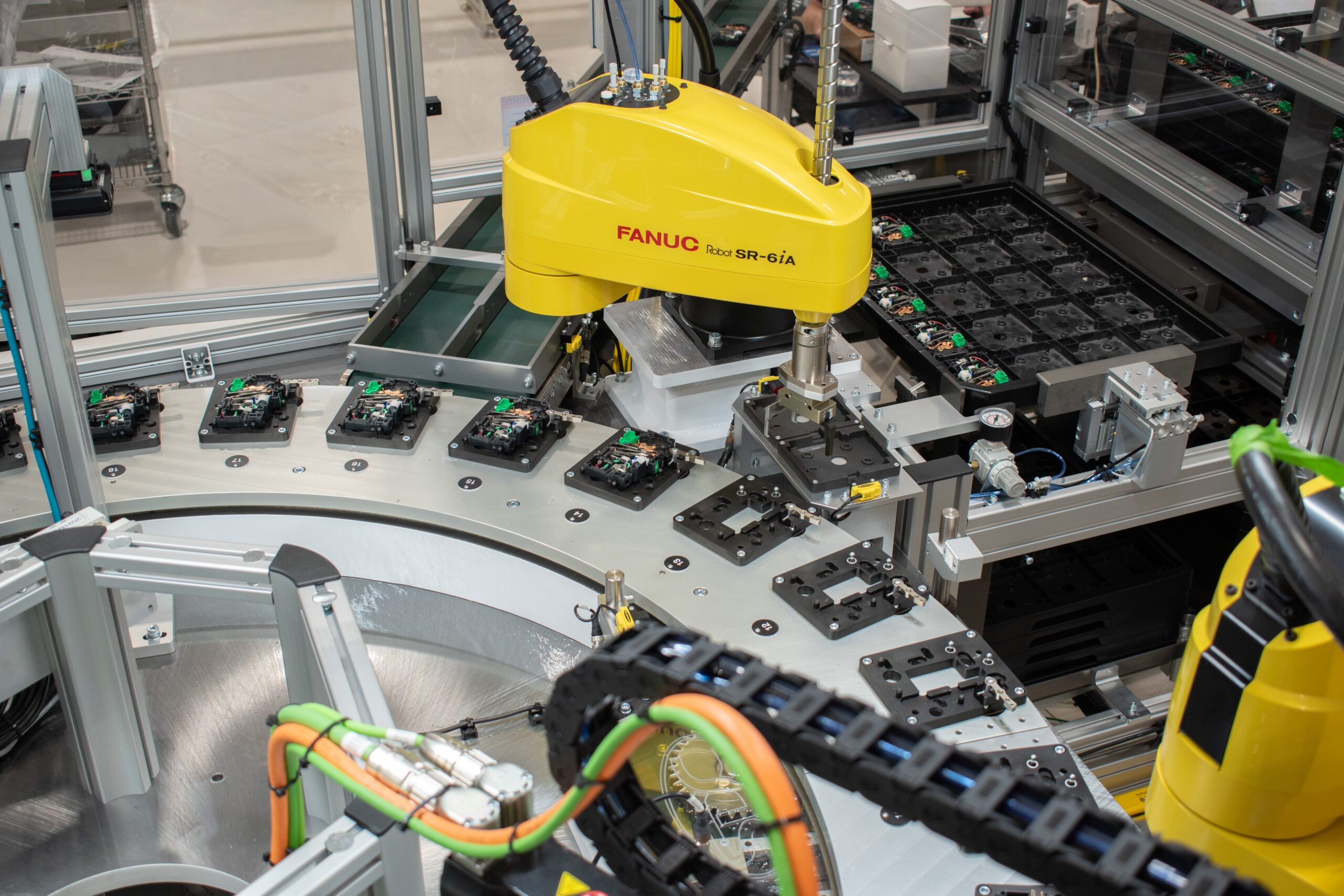 FANUC SCARA robot unloading circuit breakers on an SDC Tray Handler from an SDC Indexing Ring