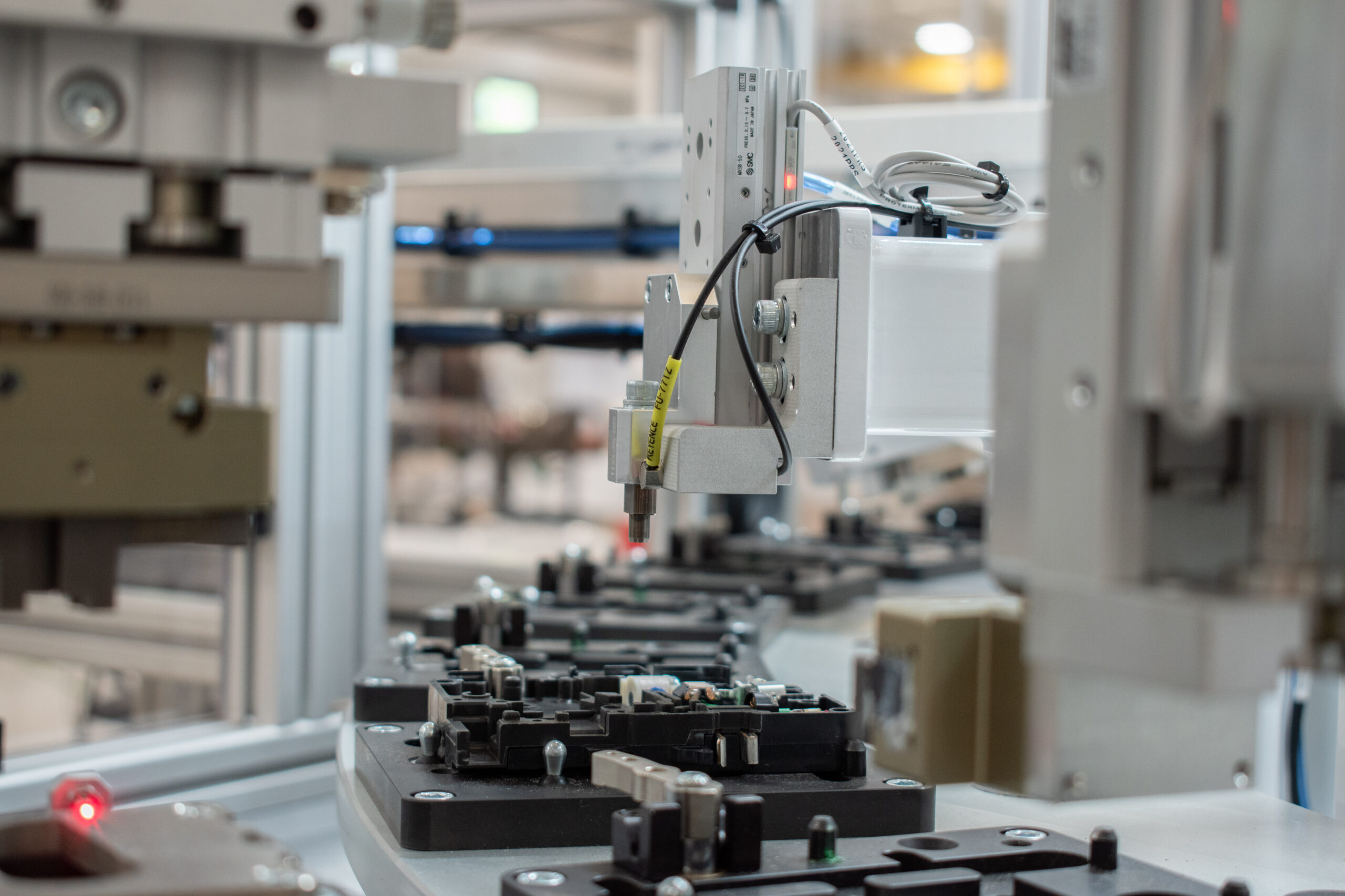 Custom-tooled station on an automated circuit breaker assembly machine