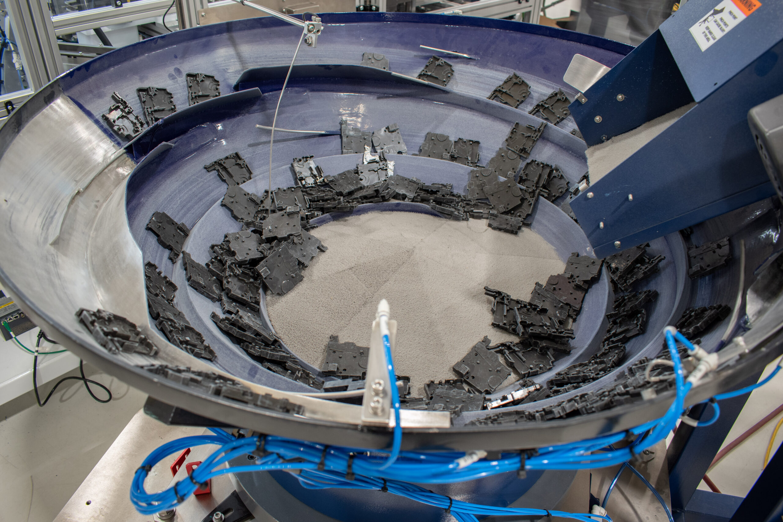 Large Bellco vibratory feeder bowl with sound-absorbing material